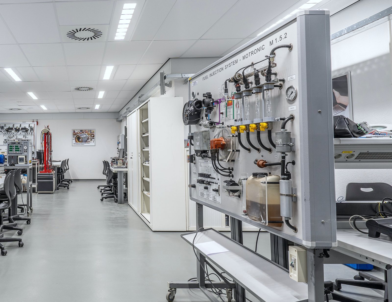 Technical test rig with gauges, valves and instrumentation in a modern engineering laboratory.